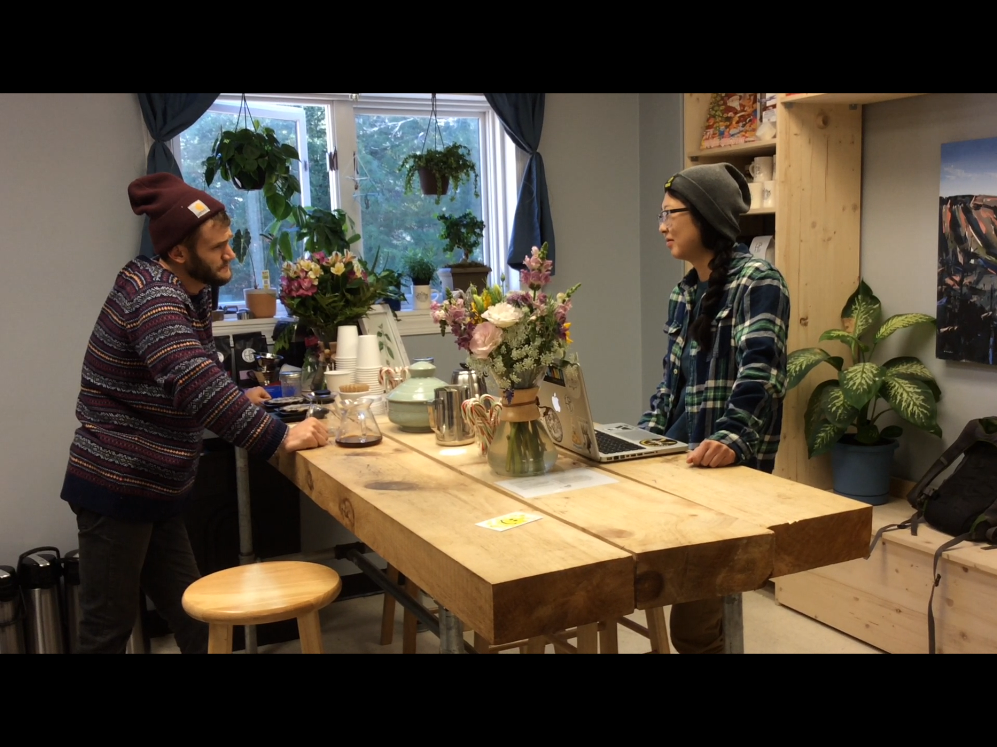 Jeremy Parnell, co-owner of Hatchet Coffee, is talking while he waits for the coffee beans to grind. 